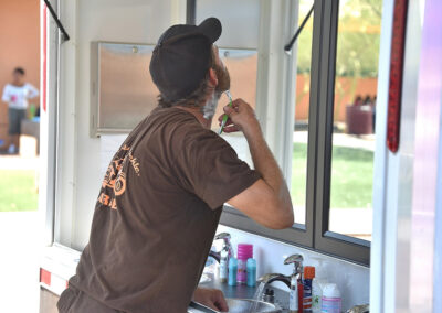 a man enjoying a shave at the shower the homeless event