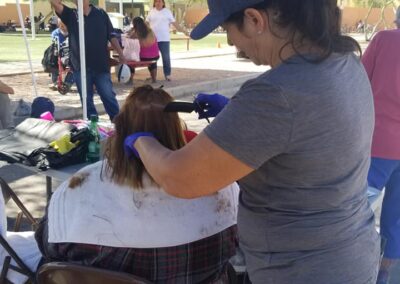 a volunteer cutting hair at our shower the homeless event