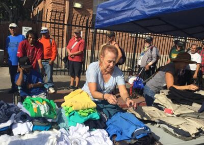 a woman looking at clothes at our 3rd shower the homeless event
