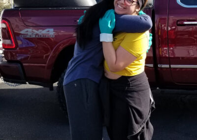 two people hugging at our christmas shower the homeless event