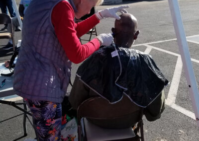 a man getting a haircut at our christmas shower the homeless event
